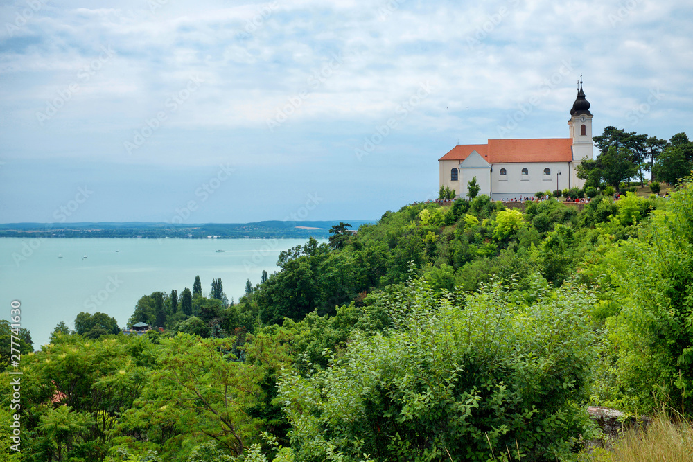 Tihany abbey with the lake Balaton and lots of green foliages in the foreground