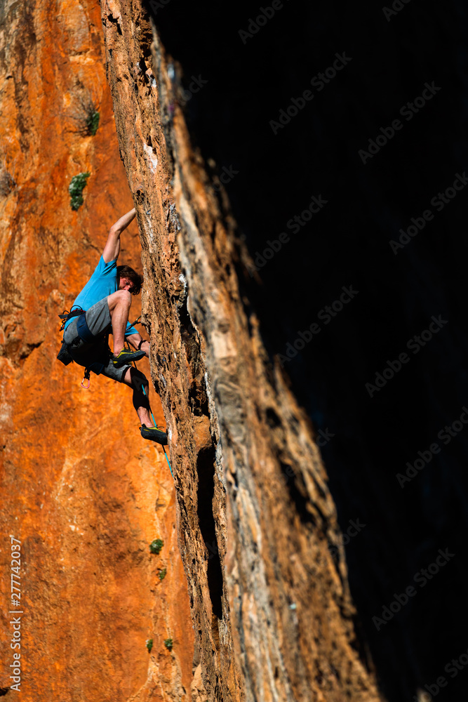 A man rock climbs in the beautiful limestone canyons of Chulilla, Spain. A man rock climbs in the beautiful limestone canyons of Chulilla, Spain.