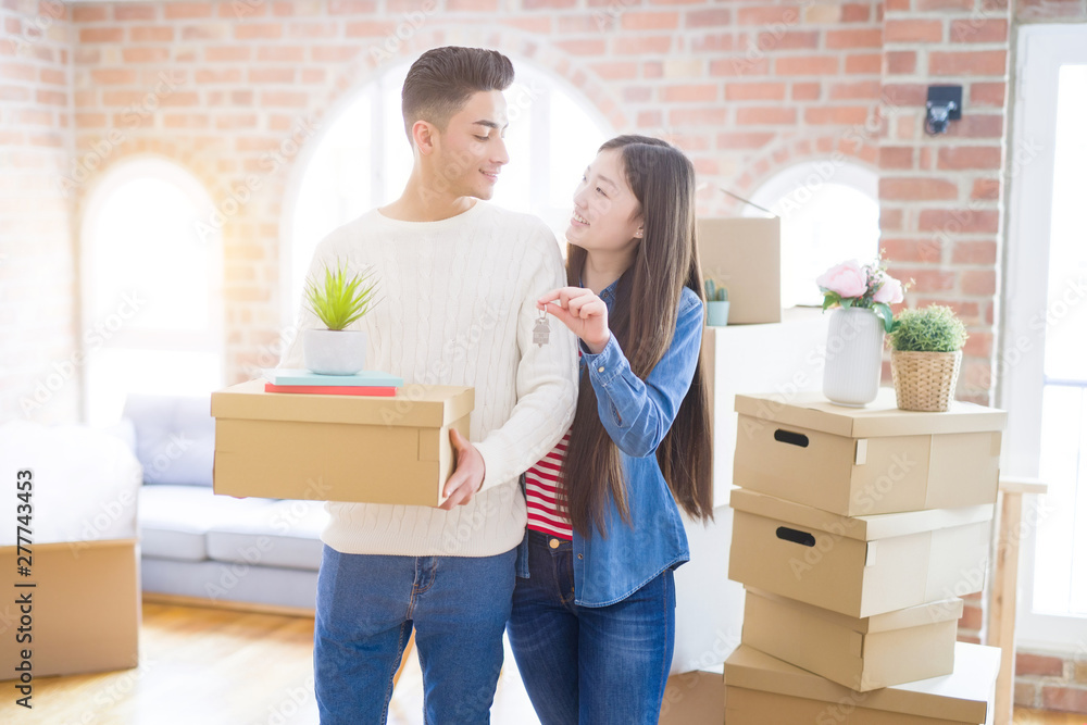 Young asian couple holding keys of new house, smiling happy and excited moving to a new apartment Young asian couple holding keys of new house, smiling happy and excited moving to a new apartment