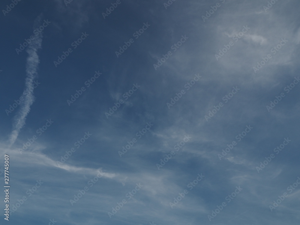 Fototapeta premium Thin clouds on a bright blue sky. 