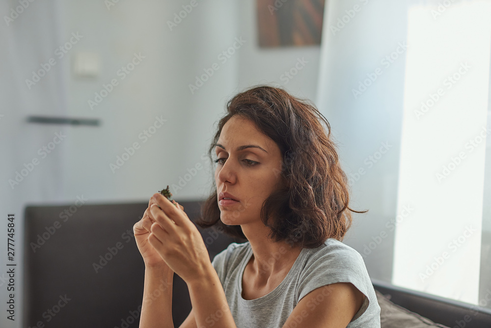 Brunette woman of latin race painting small figures with a white background. Brunette woman of latin race painting small figures with a white background.