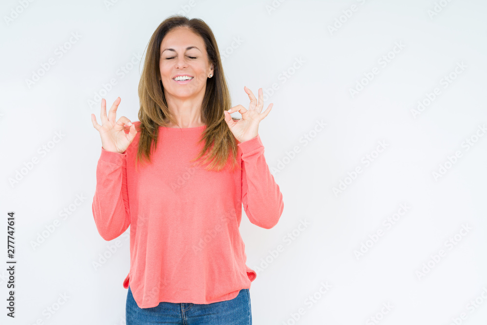 Beautiful middle age woman over isolated background relax and smiling with eyes closed doing meditation gesture with fingers. Yoga concept. Beautiful middle age woman over isolated background relax and smiling with eyes closed doing meditation gesture with fingers. Yoga concept.