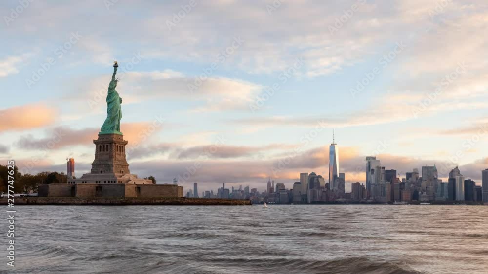 Cinemagraph view of the Statue of Liberty and Downtown Manhattan in the background during a vibrant cloudy sunrise. Taken in Jersey City, New Jersey, United States. Still Image Continuous Animation Cinemagraph view of the Statue of Liberty and Downtown Manhattan in the background during a vibrant cloudy sunrise. Taken in Jersey City, New Jersey, United States. Still Image Continuous Animation