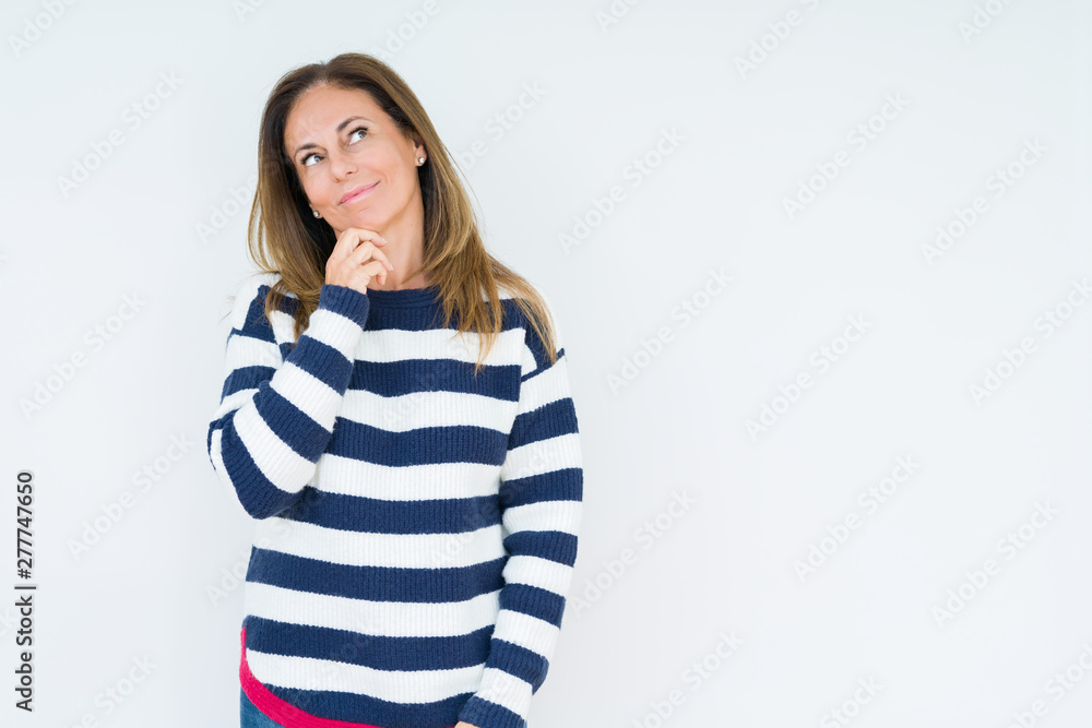 Beautiful middle age woman wearing navy sweater over isolated background with hand on chin thinking about question, pensive expression. Smiling with thoughtful face. Doubt concept. Beautiful middle age woman wearing navy sweater over isolated background with hand on chin thinking about question, pensive expression. Smiling with thoughtful face. Doubt concept.
