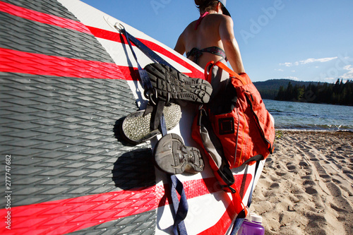 A woman carries a SUP board to the water at Priest Lake in nroth Idaho. photo