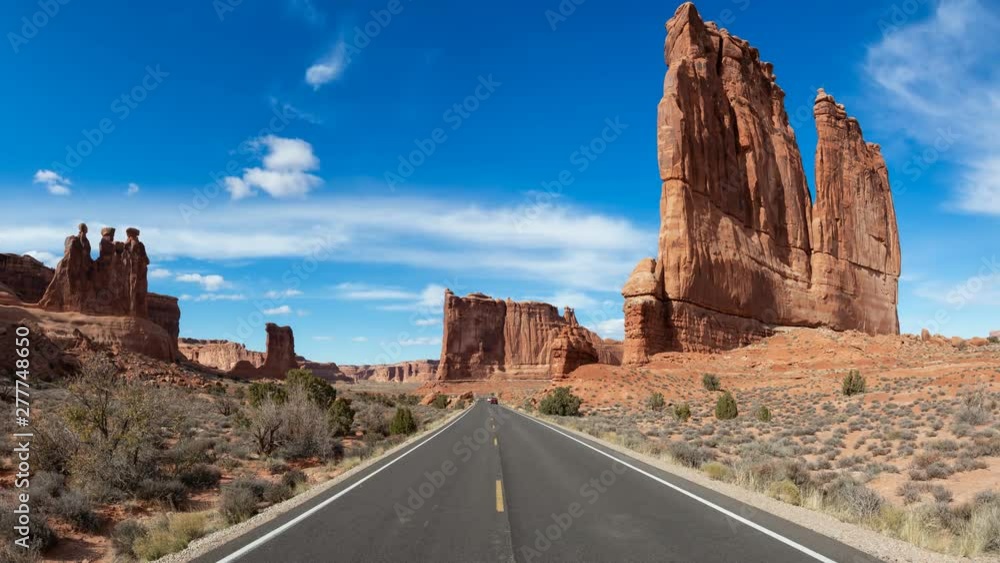 Beautiful Landscape view of a Scenic road in the red rock canyons during a vibrant sunny day. Taken in Arches National Park, located near Moab, Utah, United States. Still Image Continuous Animation Beautiful Landscape view of a Scenic road in the red rock canyons during a vibrant sunny day. Taken in Arches National Park, located near Moab, Utah, United States. Still Image Continuous Animation