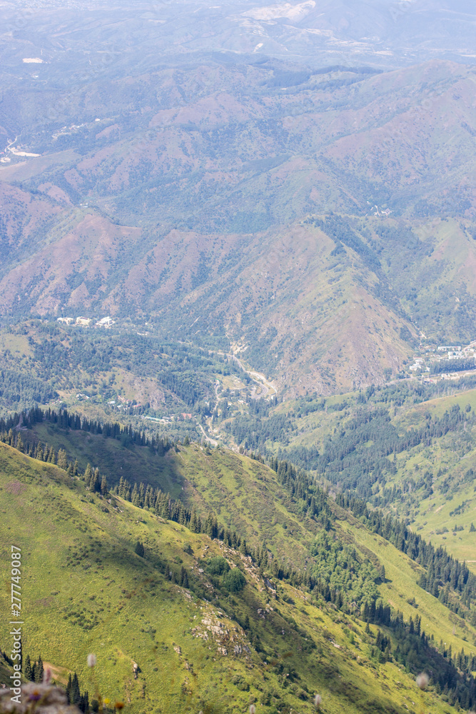 Naklejka premium View of the mountains in the summer, Almaty, Kazakhstan. View from the mountain peak Kumbel