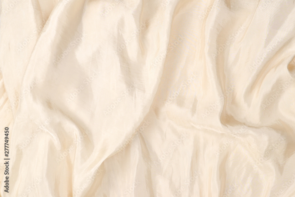 Soft smooth beige silk fabric background. Fabric texture. Soft smooth beige silk fabric background. Fabric texture.