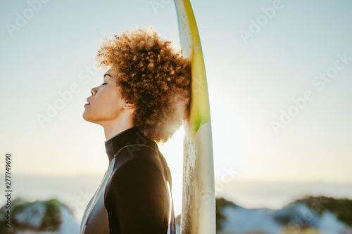 Female relaxing after surfing in the sea