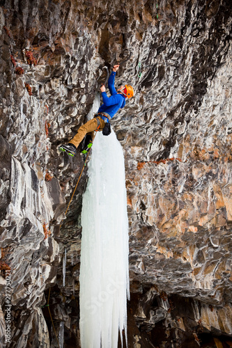 A man on Roman Candle (M9), a sustained, overhanging mixed route at Hyalite Canyon in Montana. photo