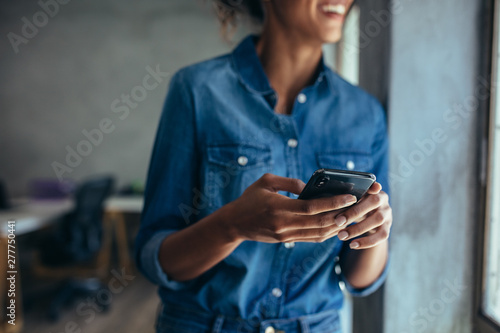 Businesswoman with mobile phone in hand photo