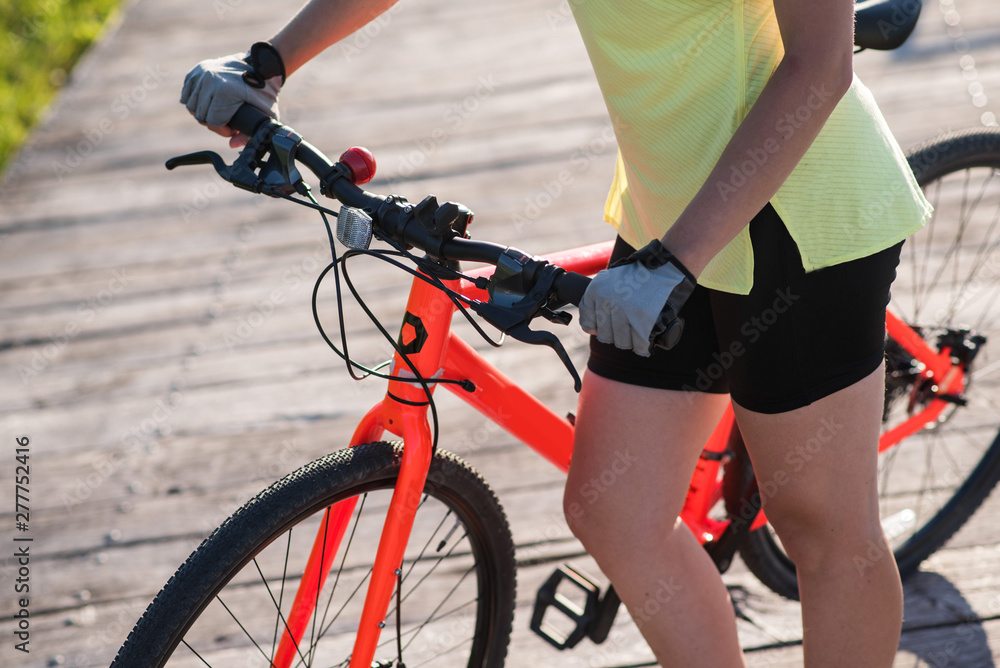 Fototapeta premium Close up womans hands on bike
