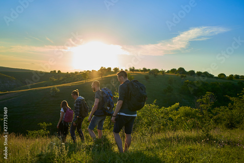 young relaxing friends enjoying exclusive nature trip