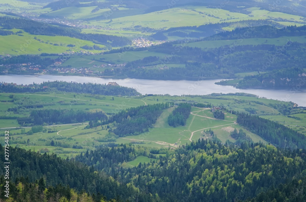 Beautiful mountain spring landscape. View of the Czorsztyn Lake and green valleys and hills. Beautiful mountain spring landscape. View of the Czorsztyn Lake and green valleys and hills.