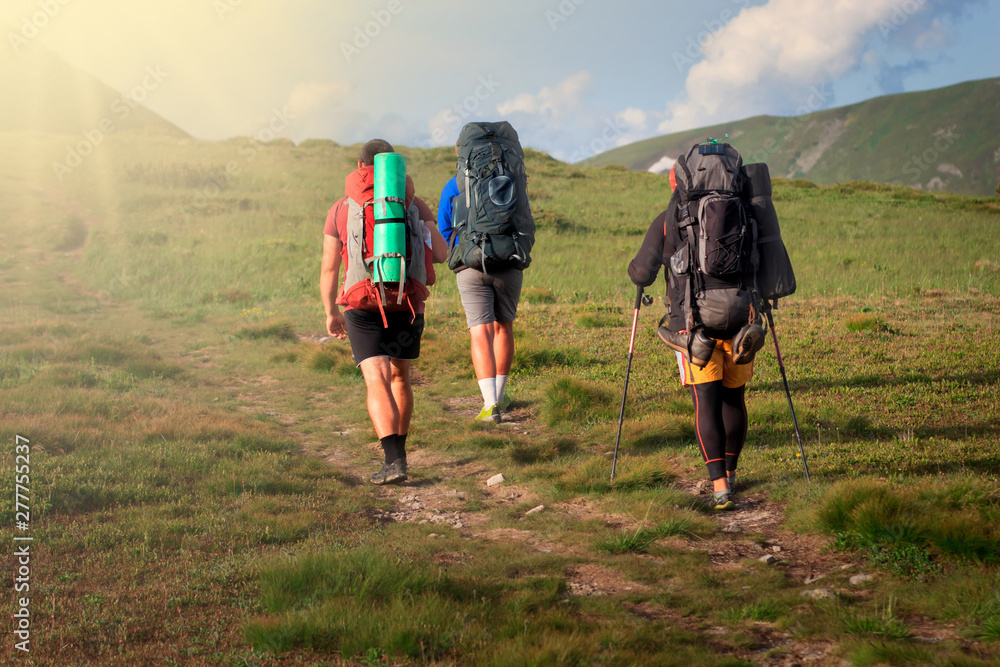 hikers walking in the mountains. goal, success, freedom and achievement concept