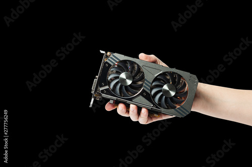 man hold graphic gpu video adapter isolated on a black background. hardware for processing with computer graphics. photo