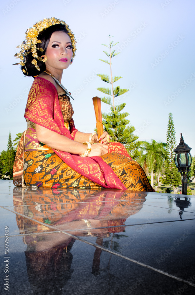 Beautiful Bali girl dress posing in beautiful nature place in Bali
