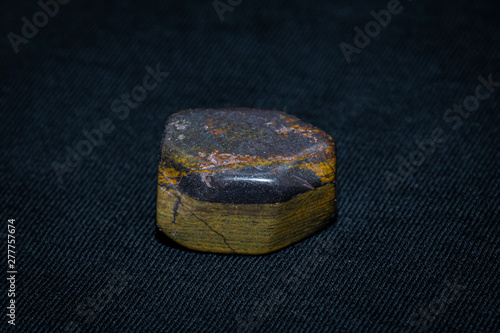 Tiger iron gemstone precious gem shiny surface yellow and grey