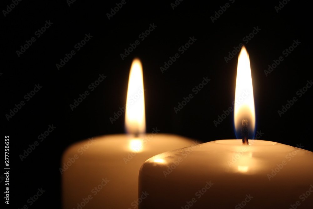 Two large white candles with small copy space at the left Two large white candles with small copy space at the left