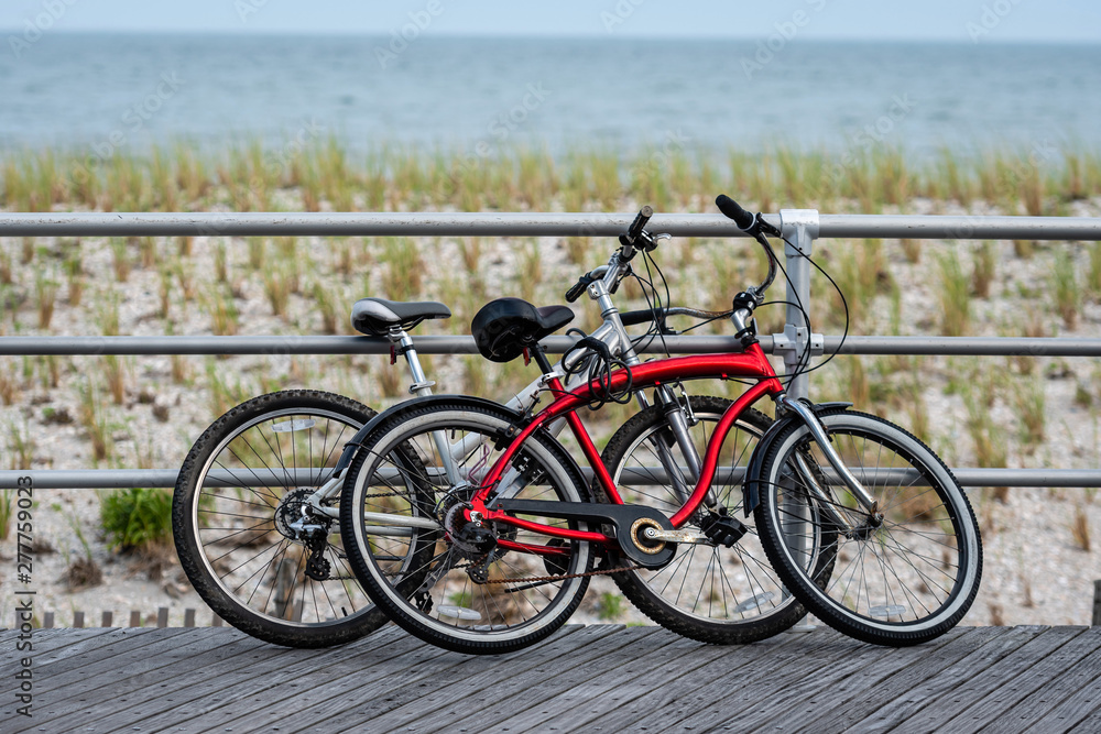 Fototapeta premium Two bicycles parked on Atlantic city beach boardwalk.