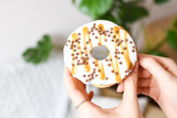 Female hand holding delicious donut