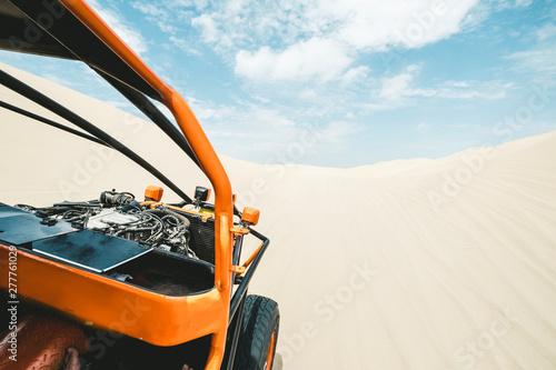 View from a sand buggy in the desert against a blue sky photo