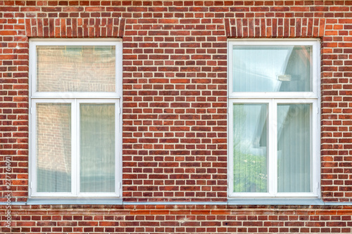 Two Windows on a brick wall.