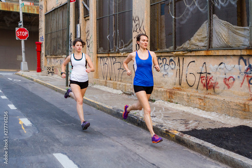 Female runners training in industrial area of Brooklyn photo