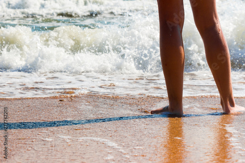 Feet barefoot girl near the water's edge by the sea © Игорь Салов