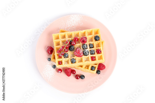 Belgian waffles with berries on plate isolated on white background