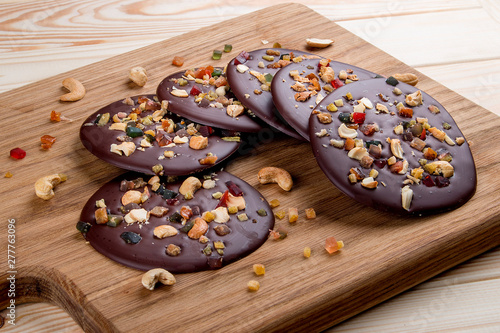 Chocolate chip cookies with cashew nuts and candied fruits on a wooden board. Dietary food. Healthy food.