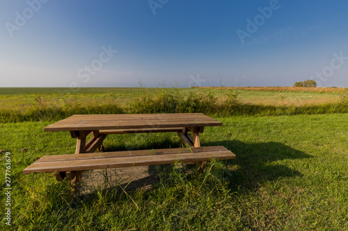 a bench with table in a meadow