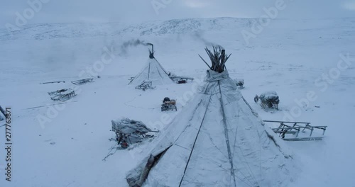 Drone capturing the yurts closeup in the evening in middle of Arctic , many sleigh outside the yurts. photo