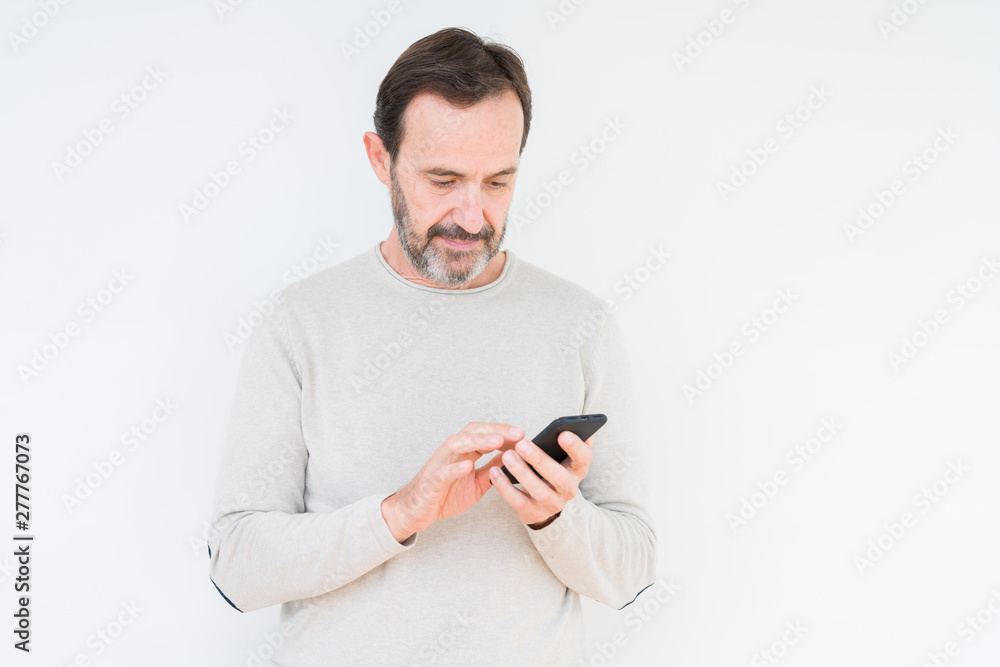 Senior man using smartphone over isolated background with a confident expression on smart face thinking serious Senior man using smartphone over isolated background with a confident expression on smart face thinking serious
