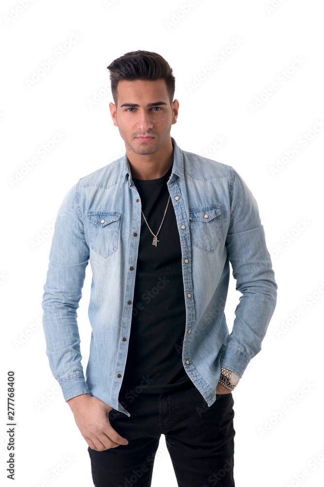 Young handsome man standing in studio shot, isolated on white, wearing denim shirt and black jeans Young handsome man standing in studio shot, isolated on white, wearing denim shirt and black jeans