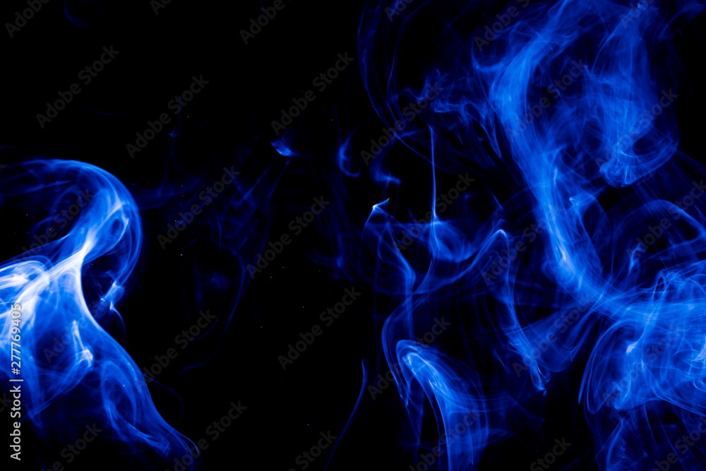 Fototapeta premium Blue smoke on black background