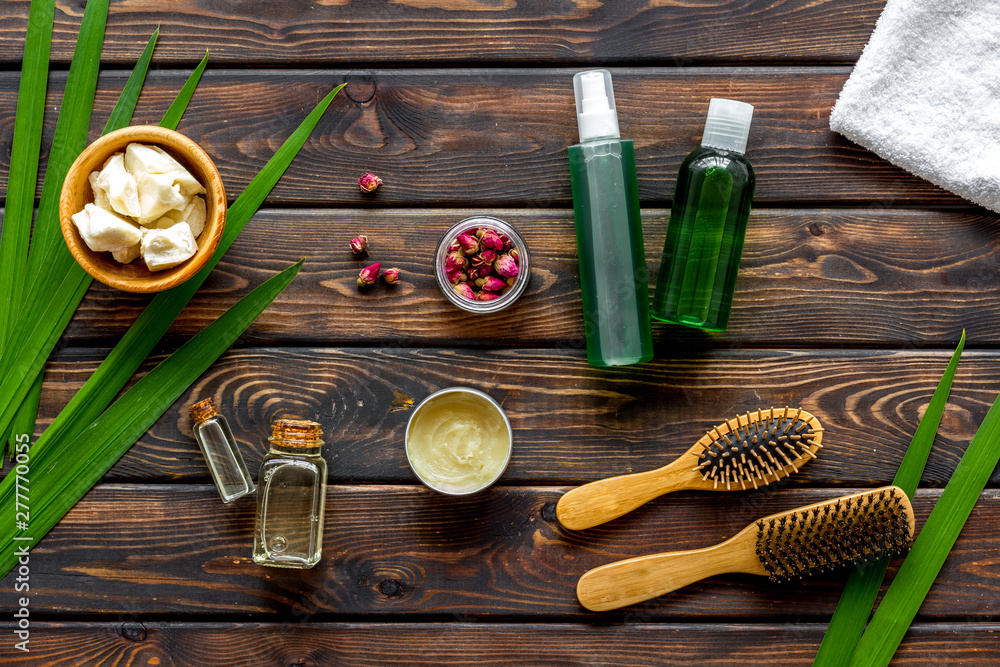 Φωτογραφία Cosmetics for hair care with jojoba, argan or coconut oil in bottle on wooden ba