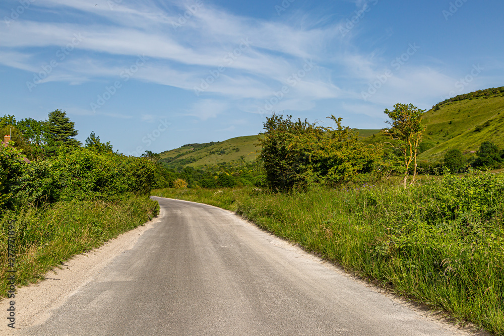 A road through the Sussex countryside on a sunny summers day