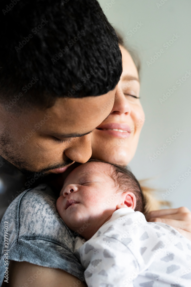 Parents cuddling newborn baby at home Parents cuddling newborn baby at home
