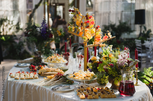 Catering banquet table at reception. Restaurant presentation, european cuisine, food consumption, party concept. Food styling, appetizers bar, welcome drink, event design.
