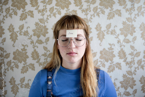 Student showing her hand, a note with the word love on her hand