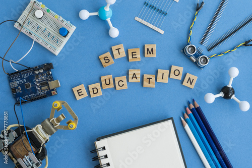 Back to school concept. A metal robot and an electronic board that can be programmed. Robotics and electronics. DIY robotics. STEM and STEAM education for kids. Free space for text.