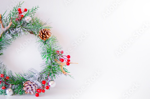 Christmas nice wreath with red berries and pinecone on white background. Christmas home decor. New year greeting card. Merry xmas and Happy New Year Family Holiday Festival Concept, flat lay