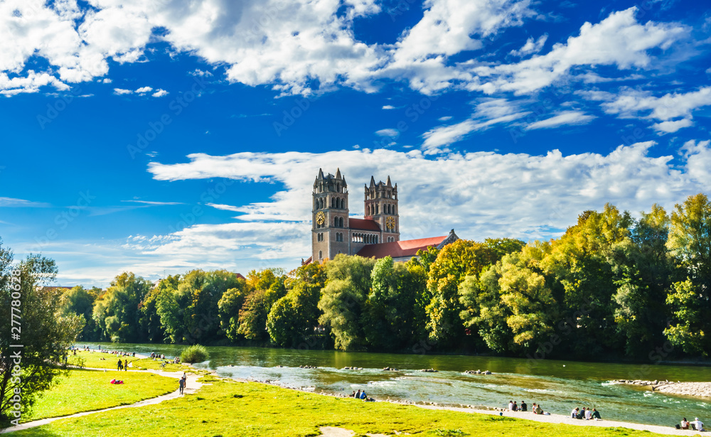 Fototapeta premium View on summer landscape by St. Maximilian church and Isar in Munich