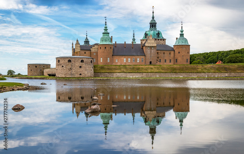 Kalmar Castle on a quiet summer morning with reflection in the calm water in the foreground.