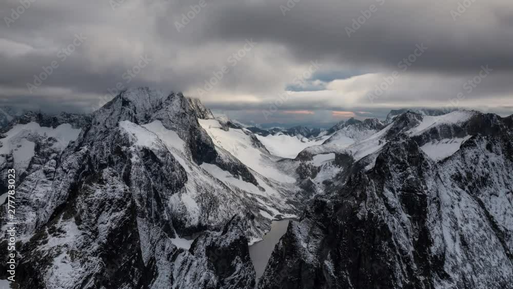 Aerial striking landscape of the rugged mountains covered in clouds. Taken far East of Seattle in Washington, United States of America. Still Image Continuous Animation Aerial striking landscape of the rugged mountains covered in clouds. Taken far East of Seattle in Washington, United States of America. Still Image Continuous Animation