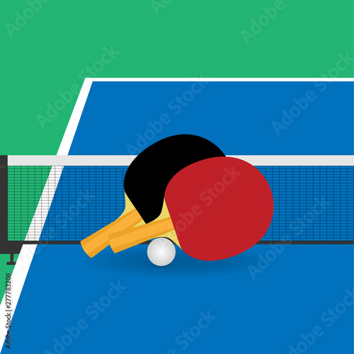 Table tennis rackets and ball near  the net