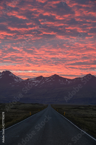 Dramatic sunset over empty road in Iceland