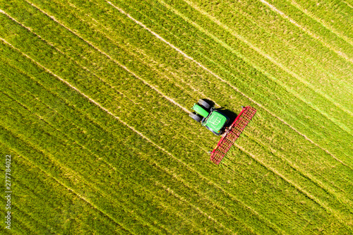 Aerial view of tractor on field, soil loosening, Hochtaunuskreis, Hesse, Germany photo