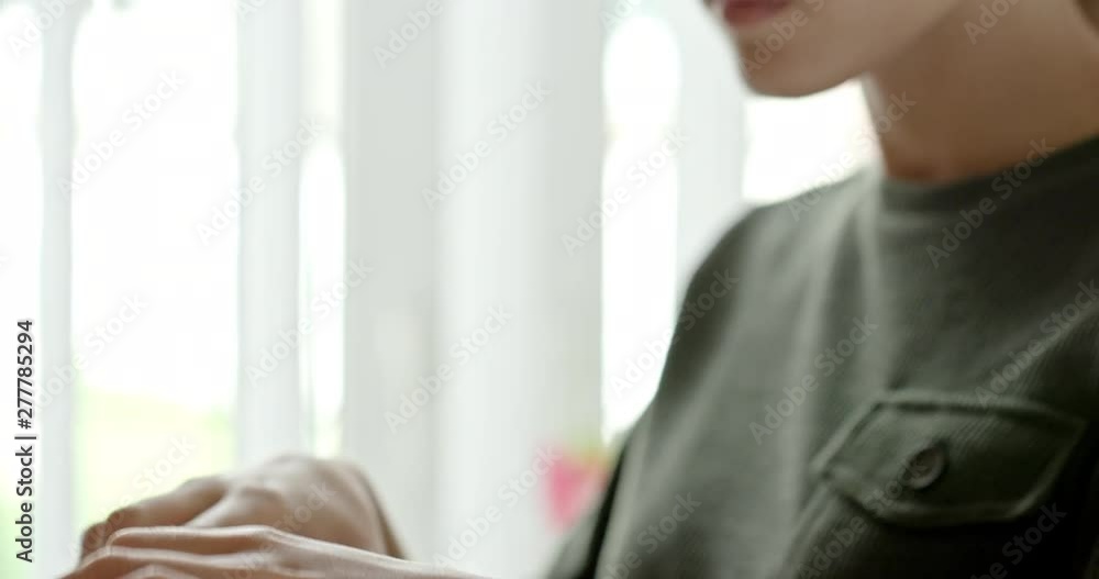 Woman wearing glasses searching through a wooden tray of index cards as she tries to locate a book or manuscript, close up. Woman wearing glasses searching through a wooden tray of index cards as she tries to locate a book or manuscript, close up.